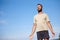 Getting away from it all. a carefree mature man standing with his palms open against a blue sky.