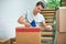 Getting everything ready for the move. a young man packing up his belongings into boxes before moving out.