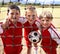 Getting a feel for the nets. Cropped portrait of three young boys standing behind the net on a soccer field.