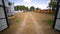 Getting through the gate to the country farming yard with forest peaks and blue sky scenic background. Art. Small wooden