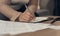 Getting hands on with fulfilling long term goals. an unrecognisable woman going over paperwork at home.