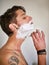 Getting a nice close shave. a handsome young man standing in the bathroom shaving.