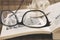 Getting ready to read Hobbit, a fantasy novel by J. R. R. Tolkien. Glasses, plastic miniature f