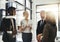 Getting some feedback from the team. four businesspeople talking while standing in the office.