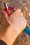 Getting a stable grip. Closeup of a climbers hands clipping a quickdraw onto a hook bolted into a rock.