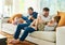 Getting their daily dose of tickles. Full length shot of an affectionate family of four on the sofa at home.