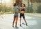 Getting their muscles ready for a workout. Full length shot of two attractive young female athletes warming up outside