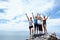 Getting to the top. Shot of a group of friends looking pleased after reaching the peak of a mountain.