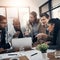 Getting the whole team on this task. a group of young businesspeople using a laptop together during a meeting in a