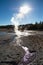 Geyser steam reaches the sun at midday in Norris Geyser Basin, Yellowstone National Park, USA