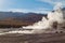 Geyser water steam on desert