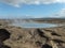 Geysir, now inactive geyser in Iceland, breathing hot steam under blue sky