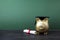 Gfold piggy bank with a grad cap and diploma in front of green chalkboard. Education scholarship