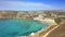 Ghajn Tuffieha, Malta - 4K flying above Ghajn Tuffieha Watch Tower and Golden Bay on a summer morning with clear sea water