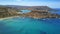 Ghajn Tuffieha, Malta - 4K flying above Ghajn Tuffieha Watch Tower and Riviera beach on a summer morning with clear sea water