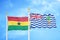 Ghana and British Indian Territory two flags on flagpoles and blue sky