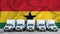 Ghana flag in the background. Five new white trucks are parked in the parking lot. Truck, transport, freight transport. Freight