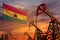 Ghana oil industry concept. Industrial illustration - Ghana flag and oil wells with the red and blue sunset or sunrise sky