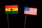 Ghanaian flag with USA flag isolated on black