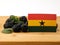 Ghanaian flag on a wooden panel with blackberries isolated on a