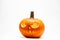 Ghastly Halloween pumpkin head jack lantern with burning candles on white background