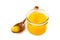 Ghee or clarified butter in jar and wooden spoon isolated