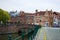 Ghent, Belgium; 10/29/2018: Typical belgian street in Patershol with green railings, Lys river and a brick bridge at the