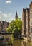 Ghent, Belgium - June 13, 2017: The clock tower of the old postal building with of the canals in the foreground