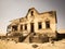 Ghost buildings of old diamond mining town Kolmanskop in Namibia