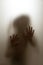 Ghost concept shadow of a child behind the matte glass blurry hand