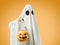 Ghost holding pumpkin basket with candy in Halloween.