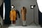 Ghost mannequin, clothes and lighting equipment in modern photo studio