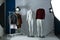 Ghost mannequins, clothes and lighting equipment in modern photo studio