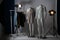 Ghost mannequins, clothes and professional lighting equipment in photo studio