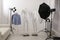 Ghost mannequins, clothes and professional lighting equipment in photo studio