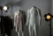 Ghost mannequins, clothes and professional lighting equipment in photo studio