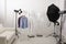Ghost mannequins, clothes and professional lighting equipment in photo studio