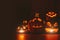 Ghost pumpkins on Halloween. ead Jack on Dark background. Holiday indoor decorations.