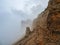 Ghost rocks. Awesome scenic mountain landscape with big cracked pointed stones closeup in misty morning. Sharp rocks background