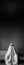 Ghost sitting on a sofa against a wall in an abandoned house. Halloween concept. Vertical banner