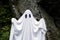 Ghost standing in front of a rock