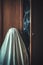 A ghost stands near an old creepy wardrobe. Halloween creature and poster for a horror film with copy space