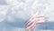 Ghosted Slow Motion American Flag Waving In Wind with Time-lapse Clouds