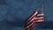 Ghosted slow motion American flag waving in wind with time-lapse clouds