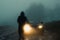 A ghostly blurred hooded figure. Moving in front of car headlights. On a spooky country track. On a misty evening in the