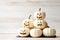 Ghostly Elegance Stack of White Pumpkin Ghosts on a White Wooden Background for Halloween Delight. created with Generative AI