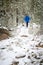 Ghostly figure hikes down a winter trail