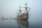 ghostly pirate ship emerging from eerie fog