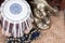 Ghungroo cymbal with dancer`s ornaments in a wooden textured tray.