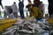 An Giang, Vietnam - Dec 6, 2016: Caught fishes with workers working at Tac Cau fishing port at dawn, Me Kong delta province of Kie